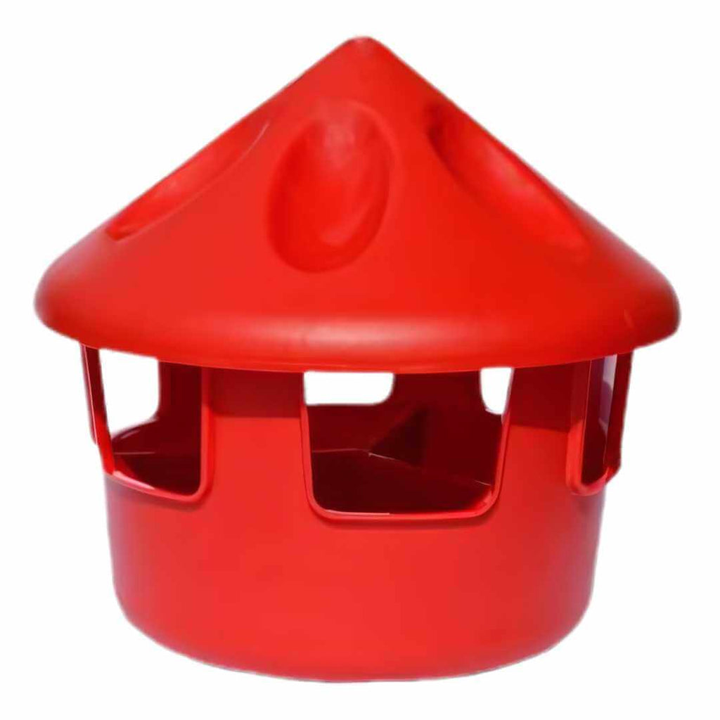 Red plastic feeder with a cone-shaped top on a white background