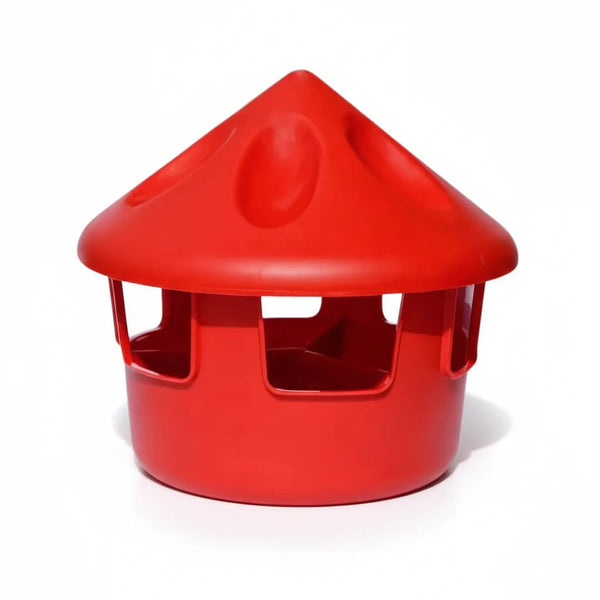 red chicken feeder and grit station on white background